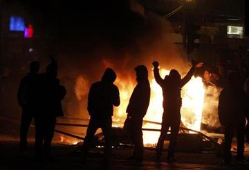 Protesters taunt the police during riots downtown in Bucharest
