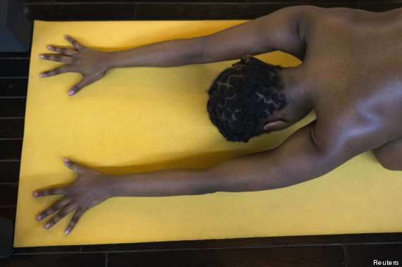Vanessa Kennedy assumes a position during the Bold & Naked yoga class in New York