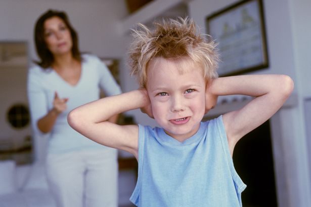 Portrait of a little boy refusing to listen to his Mum