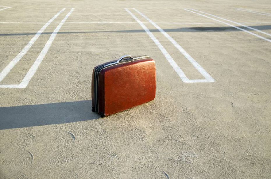 Suitcase on empty parking lot