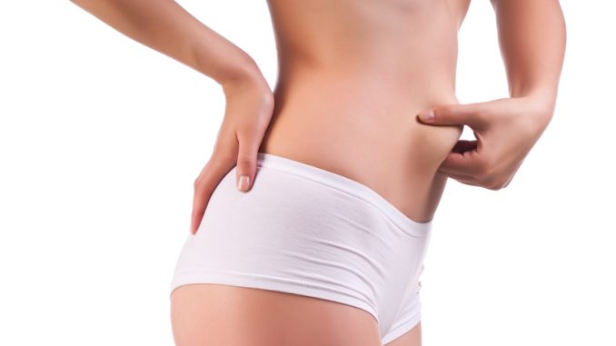 Woman pinches her fat
