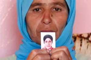 Zohra Filali the mother of rape victim Amina Filali who committed suicide last week shows a picture of her daughter at their family house in Khmis Sahel near Larache northern Morocco. Photo by AP 300x197