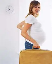 pregnant womanwith suitcase
