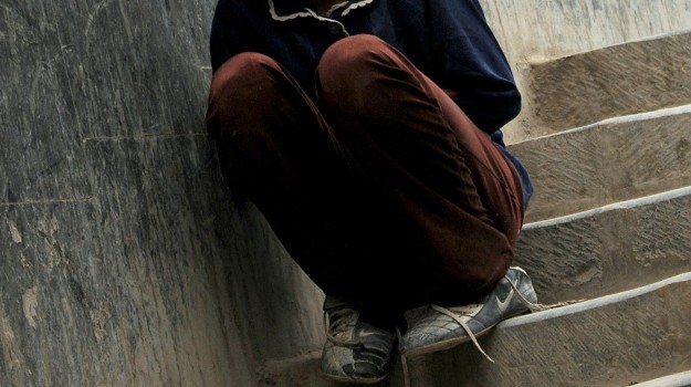 An Afghan child begs on the streets of K