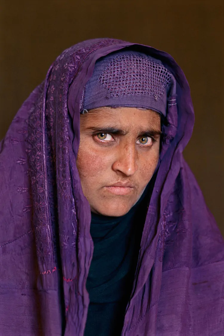 Sharbat Gula, Peshawar, Pakistan, 2002. Her skin is weathered, there are wrinkles now, but she's as striking as the young girl I photographed 17years ago. Both times our connection was through the lens. This time she found it easier to look into the