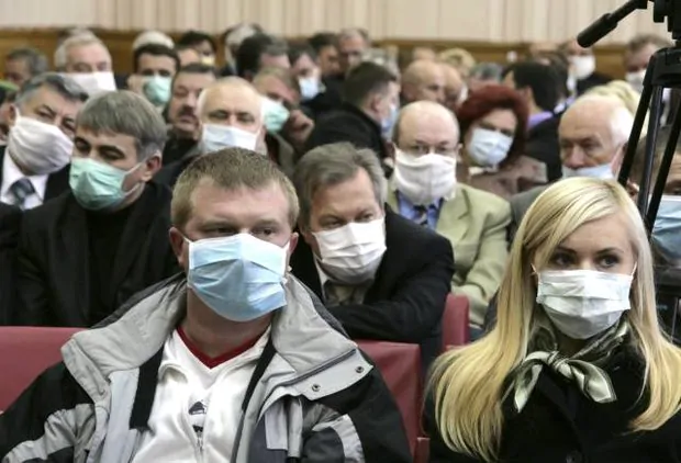 Participants of the Ministers' Cabinet session wear masks as they listen to Ukraine's Prime Minister Yulia Tymoshenko in Ternopil in western Ukraine
